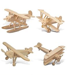 four wooden model airplanes sitting on top of each other