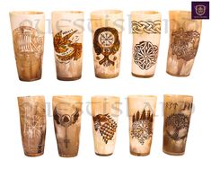 a set of nine shot glasses with different designs on each one side and the same design on the other