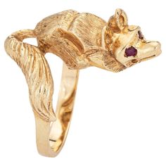 Stylish vintage fox ring (circa 1960s to 1970s) crafted in 14 karat yellow gold. Two rubies are set into the eyes and total an estimated 0.02 carats. The beautifully detailed fox is designed to lay on your finger, as if to pounce. The tail coils around the finger with rubies set to the eyes. The low rise ring (8.5mm - 0.33 inches) sits comfortably on the finger. The ring is in very good condition. We have not cleaned the ring in order to preserve the patina and collector value. Particulars: Weig Fox Ring, Vintage Fox, Red Band, Animal Jewelry, Gold Style, Cocktail Rings, Rings Statement, Statement Rings, Ruby