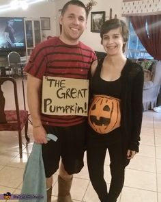 a man and woman standing next to each other in front of a tile floor with a sign that says the great pumpkin on it