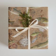 a gift wrapped in brown paper with fish on it