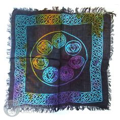 a square scarf with an image of four circles in the center on a black background