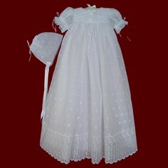 "Beautiful embroidered eyelet voile fabric with a lightweight and delicate texture create a timeless christening gown for baby girl's special day. The short puffy scalloped sleeves and front yoke are accented with French lace beading with ribbon and has a scalloped peter pan collar. Satin ribbon bow with streamers on the front bodice with sheer ribbon rosette. Gown also available with long sleeve with beading & ribbon ties. Includes a matching bonnet with scalloped edge, satin ribbon ties &a Fitted Embroidered Lace Baptism Dress, Fitted White Baptism Dress With Broderie Anglaise, Classic Fitted Baptism Dress With Broderie Anglaise, Fitted Baptism Dress With Embroidered Short Sleeves, Fitted Baptism Dress With Broderie Anglaise, Fitted Broderie Anglaise Baptism Dress, Lace Baptism Dress With Broderie Anglaise, Beaded Edge Veil, Baby Christening Gowns