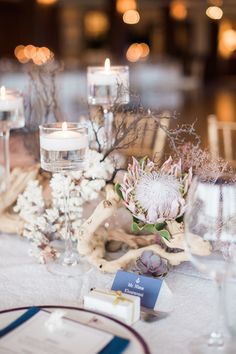 the table is set with flowers and candles