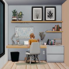 a woman sitting at a desk in front of a laptop computer on top of a wooden floor