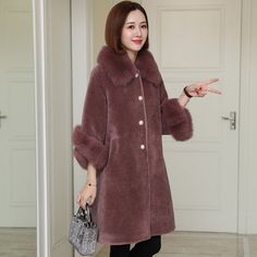 This coat is regarded as a timeless masterpiece to sport a street-smart look on cold chill days. The solid pattern makes this clothing look fantastic. This apparel for women has regular sleeve style that makes it comfortable to wear. The fox fur collar keeps it warm and fashionable all at the same time.

Specifications




Type: Slim

Thickness: STANDARD

Style: Office Lady

Sleeve Style: Regular

Sleeve Length(cm): Nine Quarter

Season: Winter

Release Date: FW2021

Place Of Origin: China (Main Single Breasted Winter Outerwear, Single Breasted Sweater Coat For Winter, Single Breasted Outerwear For Cold Weather, Single-breasted Outerwear For Cold Winter Weather, Solid Single-breasted Sweater Coat For Winter, Fall Single Breasted Long Fur Coat, Fall Single-breasted Long Fur Coat, Fall Long Single-breasted Fur Coat, Winter Wool Coat With Faux Fur Trim