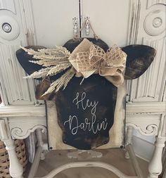 a chair with a sign that says hey borlini on it and some bows