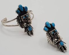 Large Kachina bracelet and ring set in sterling silver and turquoise stones is truly unique! This statement bracelet and matching ring are carefully crafted with intricate sterling silver detail work and including concho pieces on the sides and set off with lovely turquoise stones. If you love Navajo jewelry, you will love this sterling silver cuff bracelet and ring set. This kachina measures 2 inches long and sits beautifully on the sterling silver cuff. The inner circumference including the ga Handmade Southwestern Style Ring Jewelry, Handmade Southwestern Style Ring, Southwestern Style Jewelry In Sterling Silver, Southwestern Style Jewelry In Sterling Silver Stamped 925, Adjustable Silver Multi-stone Jewelry, Artisan Adjustable Multi-stone Jewelry, Artisan Multi-stone Adjustable Jewelry, Southwestern Sterling Silver Jewelry Stamped 925, Southwestern Style Jewelry Bracelet With Inlay