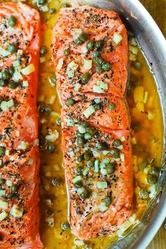 two salmons with capers and onions in a pan