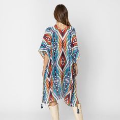 Aztec Print Kimono with Tassel Details – A Bold and Beautiful Statement Piece Add a pop of color and style to your wardrobe with this stunning Aztec Print Kimono with Tassel Details. Featuring a vibrant and eye-catching blend of brown, turquoise, orange, and white, this kimono is the perfect way to make a statement while staying comfortable and chic. Whether you’re layering it over a casual outfit or dressing it up for a special occasion, this kimono adds a touch of elegance and bohemian flair t Bohemian Multicolor Tassel Cover-up, Spring Multicolor Tasseled Cover-up, Multicolor Vacation Kaftan With Tassels, Spring Multicolor Kaftan With Tassels, Multicolor Tasseled Kaftan For Vacation, Multicolor Tassel Kaftan For Vacation, One Size Blue Cover-up For Festival, Casual Multicolor Boho Print Cover-up, Multicolor One-size Summer Kaftan