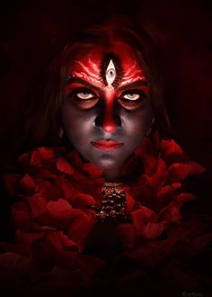 a woman with dark makeup and red flowers on her face