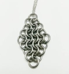 a silver necklace with an intricate design on it