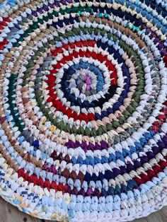 a multicolored round rug is on the floor