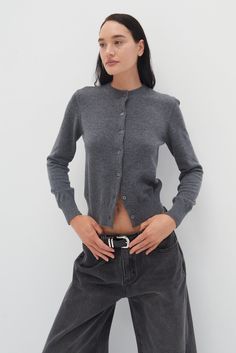 Introducing the Nikova Cardigan in Grey. The full length and ribbed hem, neckline, and cuffs provide a regular fit that keeps you cozy. Upgrade your wardrobe with this versatile and timeless piece.