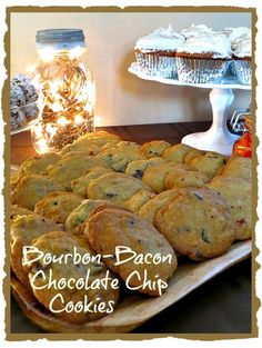 chocolate chip cookies are sitting on a platter with jars of candy in the background