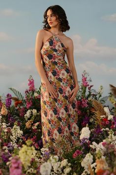 Multicolor dress with valley of flower print and halter neckline. - Aza Fashions Backless Floral Print Midi Dress For Garden Party, Floral Print Dress For Brunch And Garden Party, Elegant Backless Halter Dress With Floral Print, Backless Midi Dress With Floral Print For Brunch, Fitted Floral Print Midi Dress For Garden Party, Floral Print Midi Dress For Garden Party, Halter Neck Floral Print Dress For Party, Summer Floral Print Dress For Garden Party, Backless Floral Midi Dress For Summer