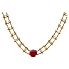 This exquisite necklace by acclaimed jeweler Jose Hess is a true showstopper. The centerpiece is a breathtaking 1.58 carat natural Burmese ruby, renowned for its highly coveted "pigeon's blood" red hue. The vivid ruby weighs 1.58 carats and measures an impressive 7mm in diameter, secured in an elegant 4-prong setting of 18k yellow gold. Radiating outwards, 26 shimmering diamond links are suspended between two delicate snake chains, allowing the piece to drape sensuously around the neckline with a fluid, silky movement. The round brilliant diamonds total 1.02 carats in weight, each stone graded G color and VS2 clarity to maximize their brilliant sparkle. An undeniable luxury piece, the 18k yellow gold necklace has a substantial weight of nearly 15 grams. With a classic 15.5-inch length, it Ruby Diamond Necklace, Ruby And Diamond Necklace, Burmese Ruby, Modern Gold Jewelry, Jewellery Sketches, Yellow Gold Necklace, Diamond Chain, Blood Red, Ruby Diamond