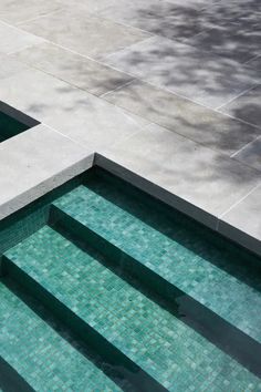 an empty swimming pool with steps leading up to it