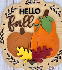 a wooden sign that says hello fall with pumpkins and leaves