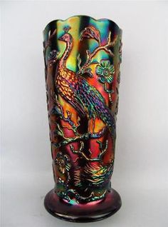 a colorful glass vase sitting on top of a table