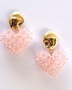 "Beaded heart earrings in pink. These beaded earrings are individually hand-beaded acrylic crystals finished with stone shapped gold plated brass earrings. Measures : 4.5 cm / 1.8\" Drop Materials : Acrylic beads, Gold plated brass post with sterling silver stud." Gold Crystal Heart Shaped Earrings, Gold Beaded Dangle Heart Earrings, Pink Heart Crystal Earrings For Valentine's Day, Pink Heart-shaped Crystal Earrings For Valentine's Day, Gold Heart-shaped Crystal Earrings, Gold Crystal Heart Earrings, Gold Heart Shaped Crystal Earrings, Valentine's Day Gold Crystal Earrings, Pink Beaded Heart Earrings For Party