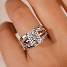 a woman's hand with an engagement ring and diamond set on top of it