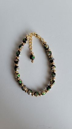 This bracelet is made of round Cloisonné' beads and gold-plated beads and findings including a 1" extension with a beaded drop and a lobster claw clasp.  Cloisonné is the technique of creating designs on metal vessels (cloisons) with colored-glass paste placed within enclosures made of copper or bronze wires, which have been bent or hammered into the desired pattern.  Custom Orders are always welcome! Ask about free sizing. Colorful Round Bead Metal Bracelets, Colorful Beaded Metal Bracelets, Colorful Round Beaded Metal Bracelets, Metal Bracelets With Black Round Beads, Metal Beaded Bracelets With Gold Beads, Gold Beaded Dangle Charm Bracelet, Gold Beaded Metal Bracelets, Gold Bracelet With Lobster Clasp And Round Beads, Adjustable Czech Glass Jewelry With 8mm Beads