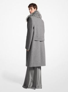 A study in opulent simplicity. Made in Italy from sculptural wool melton, this elegant double-breasted coat in our versatile Banker hue is made even more glamorous with lush faux fox trim at the collar. Part of our Fall/Winter 2024 runway collection, it’s a luxe and versatile piece destined to be in your rotation for seasons to come. Elegant Wool Coat With Faux Fur Trim, Formal Wool Coat With Faux Fur Trim, Elegant Fitted Wool Coat With Faux Fur Trim, 2024 Runway, Fall Winter 2024, Michael Kors Collection, Double Breasted Coat, Runway Collection, Winter 2024