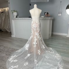 a wedding dress on display in a bridal shop