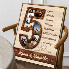 a wooden sign with the number five and photos on it, in front of a chair