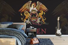 a bedroom with an eagle and two lions painted on the wall next to a guitar