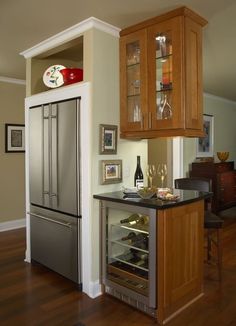 a kitchen with an oven, refrigerator and wine rack