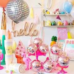 a table topped with lots of candy and balloons