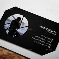 a black and white business card with an image of a man in a circle on it