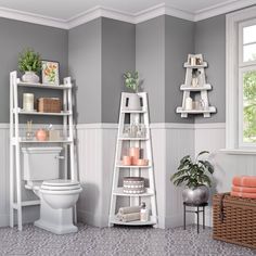 a white toilet sitting in a bathroom next to a tall shelf filled with candles and other items