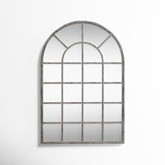 an arched window is shown against a wall with a mirror on the front and side