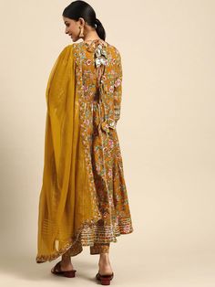 This is a beautiful 3-piece set. The set comes with floral print & gota patti detailing angrakha kurta has round neck, calf length and 3/4th sleeves teamed with printed trouser pants and a chiffon dupatta. Total No of Set-3 Kurta Fabric: Cotton Bottom Fabric - Cotton Dupatta Fabric-Chiffon Work Done - Gota Patti & Print Detailing. Sleeve Length: 3/4th Sleeves Color: Yellow Occasion: Party Wear Washing Instructions: Hand Wash or Dry Clean Spring Anarkali Set With Straight Kurta And Dupatta, Spring Straight Kurta Sets With Dupatta, Spring Sets With Straight Kurta And Dupatta, Yellow Floral Print Sets For Festivals, Traditional Wear With Gota Work For Spring, Bollywood Style Straight Kurta Sets For Spring, Semi-stitched Straight Kurta Anarkali Set For Spring, Spring Churidar With Straight Kurta And Dupatta, Spring Anarkali Kurta With Sheer Dupatta