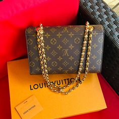 Authentic Louis Vuitton.Bought It Brand New. Gold Chain Shoulder Or Crossbody Bag.Monogram With Smooth Black Colored Leather,Gold Hardware,Metal Clasp Closure ,Outside Pocket And Gold Chain Strap Not Removable.It Comes With Box And Dust Bag. Luxury Monogram Canvas Evening Bag, Luxury Monogram Canvas Shoulder Bag For Everyday, Luxury Monogram Canvas Shoulder Bag, Luxury Gold Monogram Canvas Shoulder Bag, Elegant Everyday Monogram Canvas Shoulder Bag, Luxury Shoulder Bag In Monogram Canvas With Original Box, Luxury Monogram Canvas Shoulder Bag With Original Box, Luxury Travel Bags With Chain Strap, Travel Bag With Chain Strap And Monogram Canvas