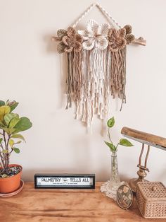 a wooden table topped with plants and a book