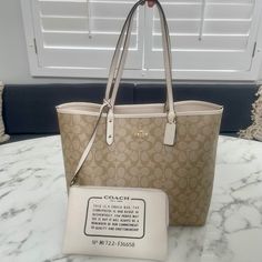 This Is An Original Coach Reversible Tote In Signature Canvas On One Side And In The Color Ivory On The Other. The Tote Comes With A Pouch In Ivory Color And Black Lettering Describing The Purpose Of The Pouch And Its Authenticity (Serial Number). The Totes Accents Are In Shiny Brass. Measurements: 13” X 11.5” X 6” With A Handle Drop Of 10”. The City Tote Is An Everyday, On The Go Bag, It Is Lightweight And It Can Carry All You Could Need On A Busy Day Or You Could Use It As A Carryon On Your Ne Coach Bags With Removable Pouch In Cream, Coach Cream Bags With Removable Pouch, Coach Cream Pouch Shoulder Bag, Coach Cream Shoulder Bag For Daily Use, Coach Beige Bag With Interior Card Slots, Coach Beige Shoulder Bag With Dust Bag, Coach Cream Shoulder Bag For Travel, Beige Coach Shoulder Bag With Dust Bag, Elegant Reversible Shoulder Bag For Travel