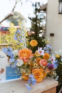 a bouquet of flowers sitting on top of a wooden table