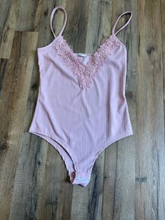 Beautiful lightweight bodysuit with floral lace detail along neckline. This is the perfect feminine complement to a pair of jeans. 93% Rayon7% Spandex Made In USA. Spaghetti Strap Bodysuit, Strap Bodysuit, V Neck Bodysuit, Lace Detail, Floral Lace, Spaghetti Strap, Made In Usa, Spaghetti, Spandex