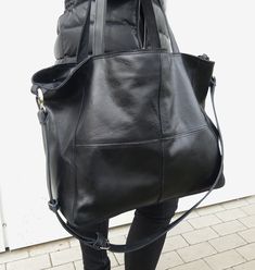 Leather bag in black, soft and big. The front decorative stitching Bag Zippered. Handles 58 cm. Complete with a long strap, you can adjust the length to be worn on the arm, max. l. 110 cm. Leather soft, genuine leather, high quality. In the middle the lining; inside a large zip pocket and a smaller leather pocked on the phone. h. 34cm, width 54 cm, depth of 16 cm . If you want a bag of this leather in other dimensions - write in the comments to the order, the price does not change. Free standard Versatile Black Leather Shoulder Bag, Black Leather Backpack Satchel, Modern Black Leather Hobo Bag, Black Leather Shoulder Bag With Leather Handles, Black Leather Hobo Bag For Daily Use, Versatile Black Hobo Bucket Bag, Black Canvas Hobo Bag For Daily Use, Black Hobo Bag Backpack For Daily Use, Black Soft Leather Bucket Bag For Daily Use