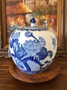 a blue and white vase sitting on top of a wooden table