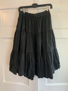 Vintage Rockmount Tru-West Ranch Wear Western Square Dance Black Cotton Skirt. Midi length and full style. Back zipper and part of the waist band is elastic. No size tag but the waist size (not stretched) is about 28 and it goes to 30”. So it’s about an 8-10. No issues just a tiny tear on the inside of the waistband lining. See photo. Thanks for looking:) Vintage Tiered Skirt Bottoms For Spring, Rock Style Cotton Skirt For Spring, Spring Cotton Rock Style Skirt, Summer Retro Solid Color Skirt, Rock Style Lined Skirt, Rock Style Summer Skirt, Vintage Tiered Skirt For Summer, Rock Style Skirt For Summer, Retro Black Long Skirt