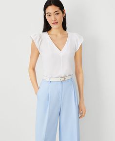 Elevate your wardrobe with the Ann Taylor Flutter Sleeve Top, a testament to meticulous design and feminine charm. This top features:

- Size: XL
- Color: White
- Gender: Female
- Material: 59% Cotton, 41% Polyester
- Fit: Softly fitted
- Length: 24 inches long
- Neckline: V-neck
- Sleeves: Short flutter sleeves with shirred sleeve caps
- Special Features: Smocked shoulders
- Care Instructions: Machine washable

Crafted to flatter, the smocked shoulders and flutter sleeves add a touch of eleganc Shirred Sleeve, Hip Style, Taylor White, Flutter Sleeve Top, Flutter Sleeves, V Neck Tops, Flutter Sleeve, Effortless Style, Ann Taylor