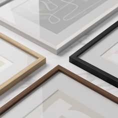 several different types of frames on a white surface with black and brown trims,