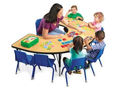 a group of children sitting around a table playing board games