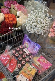 a shopping cart filled with lots of different types of flowers and pastries next to each other