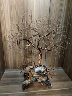 a tree sculpture sitting on top of a wooden table